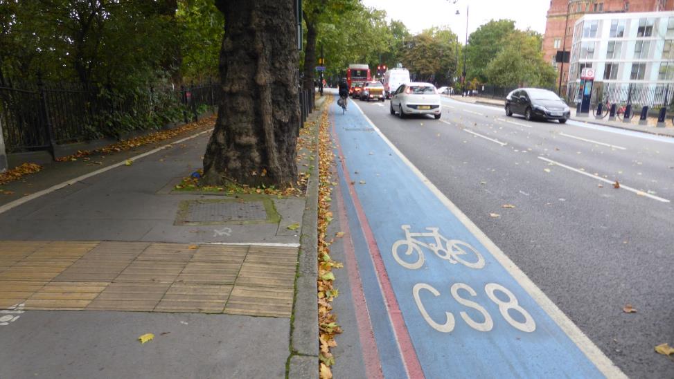 CS8, one of the first-generation cycle highways in London with characteristic blue surface. Green strip next to the fence on the far-left side is an old off-road cycling path.
