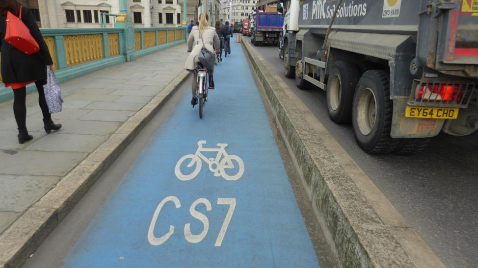 CS7 on Southwark Bridge. Cycle lanes protected by high kerbs.