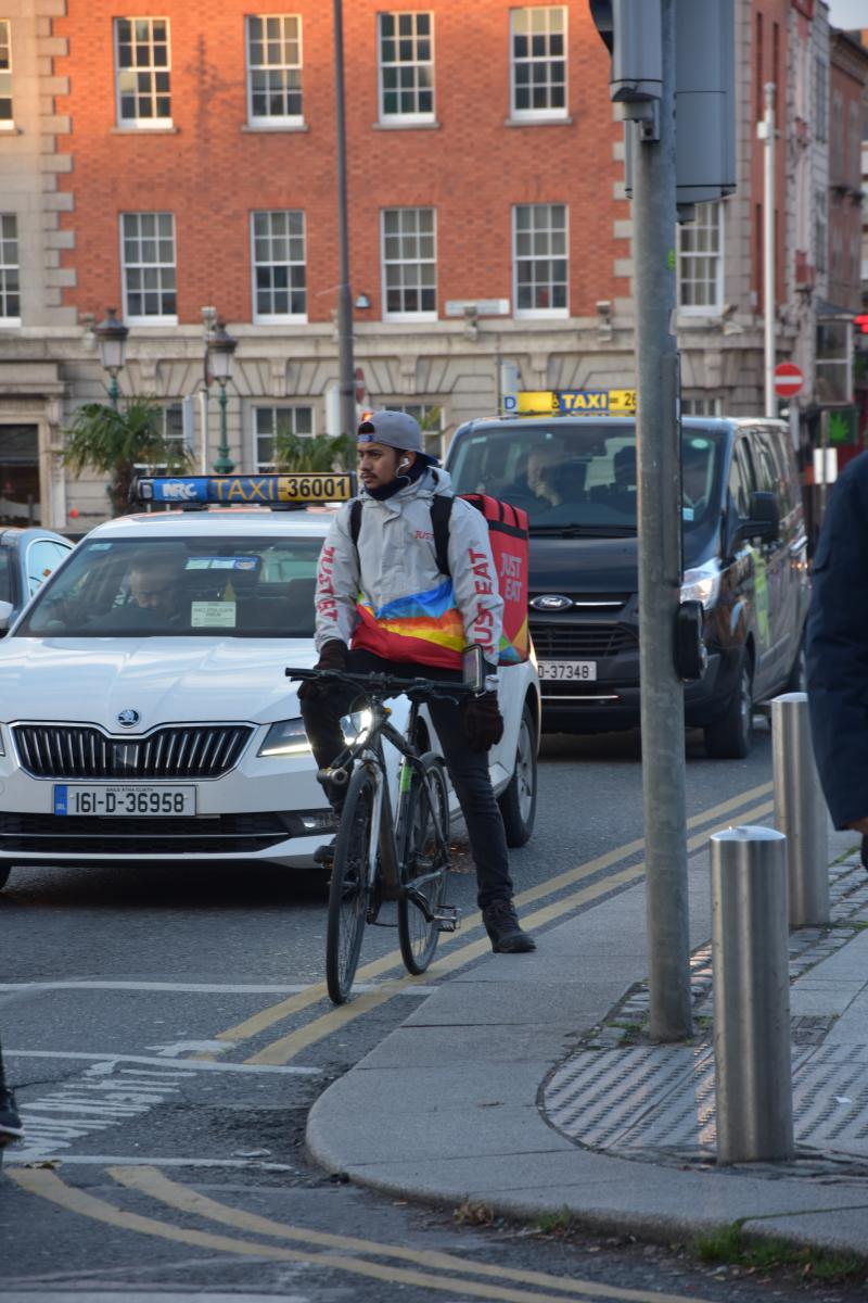 Dublin Delivery Cyclist waits at traffic lights