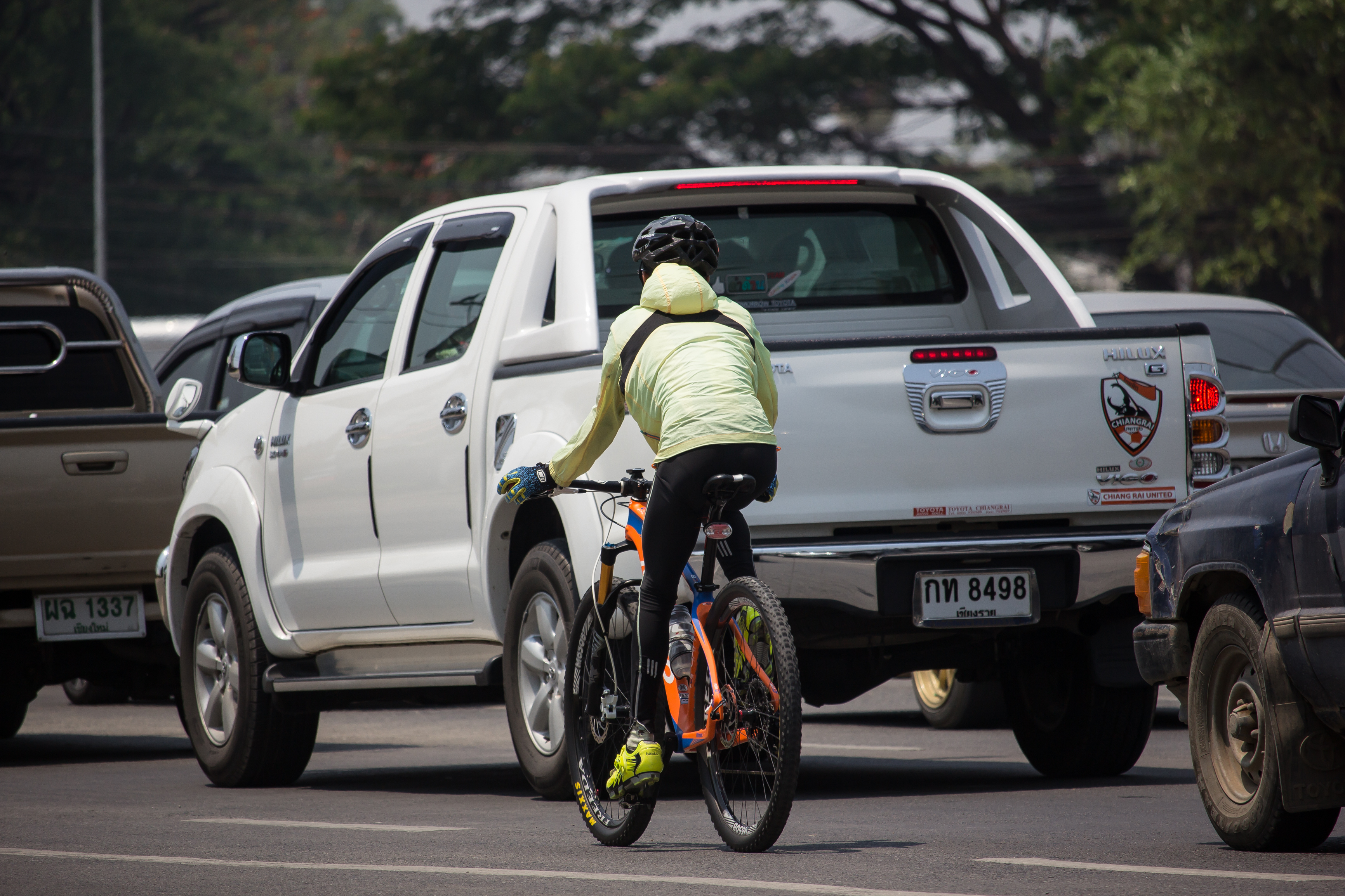 Cyclist next to pick-up truck